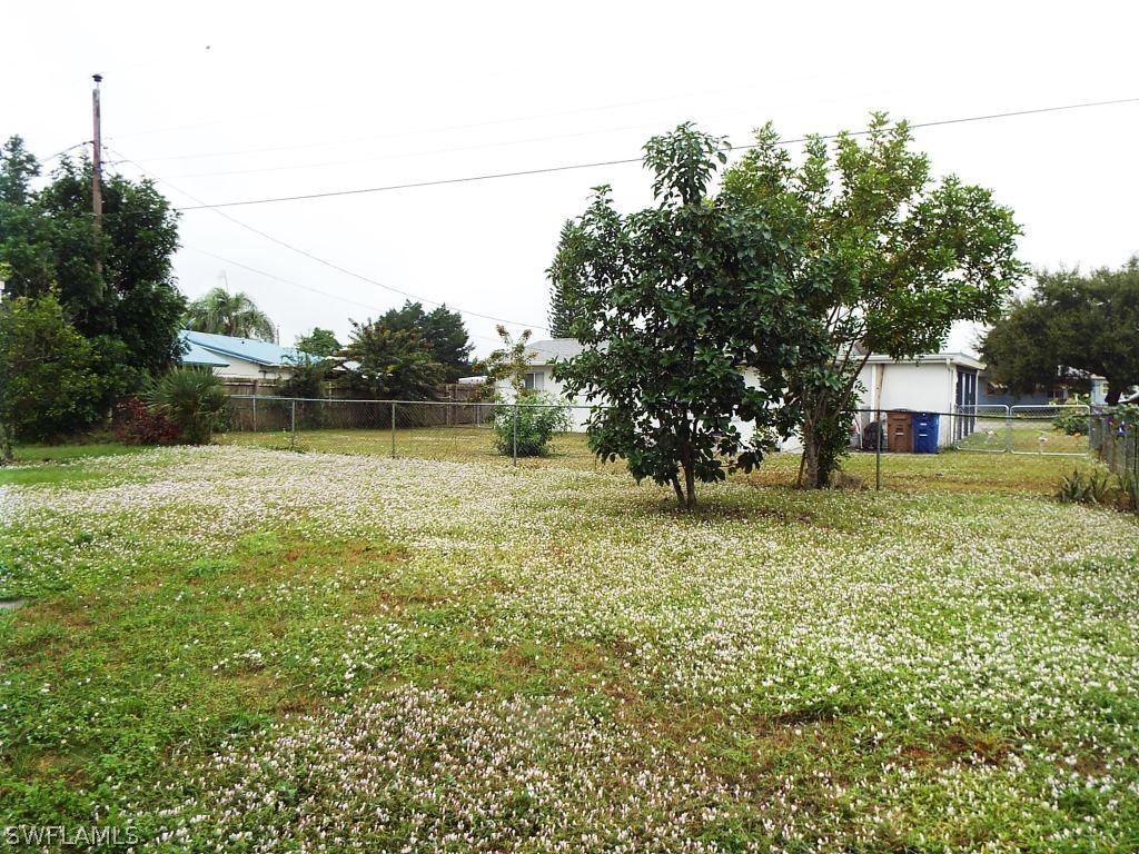 29 Andros Street Lehigh Acres, FL 33936 - Photo 14 of 16 a backyard of a house with lots of green space