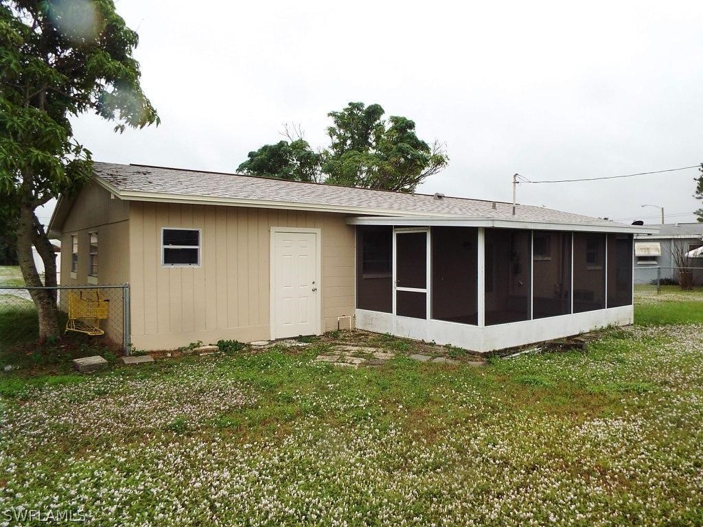 29 Andros Street Lehigh Acres, FL 33936 - Photo 15 of 16 a view of a house with a yard