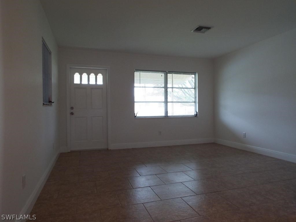 29 Andros Street Lehigh Acres, FL 33936 - Photo 2 of 16 an empty room with windows
