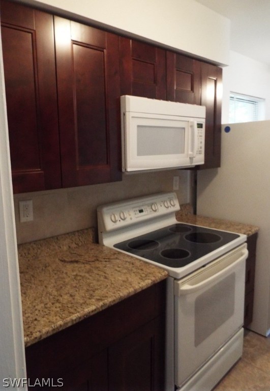 29 Andros Street Lehigh Acres, FL 33936 - Photo 5 of 16 a utility room with washer and dryer
