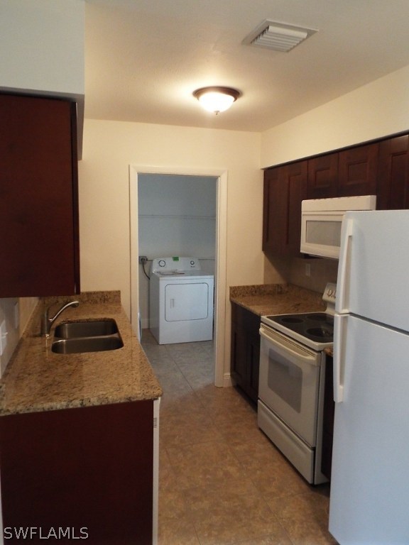 29 Andros Street Lehigh Acres, FL 33936 - Photo 6 of 16 a kitchen with granite countertop a sink stove and refrigerator
