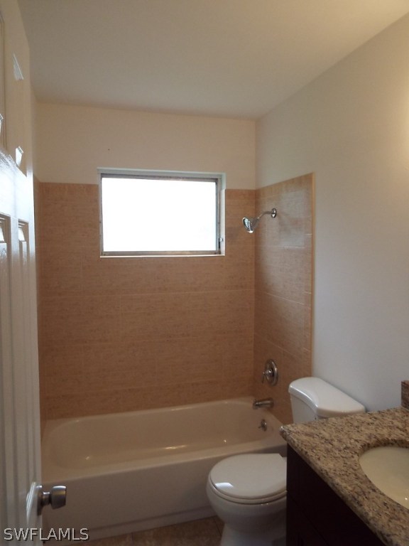 29 Andros Street Lehigh Acres, FL 33936 - Photo 10 of 16 a bathroom with a granite countertop sink a toilet and shower