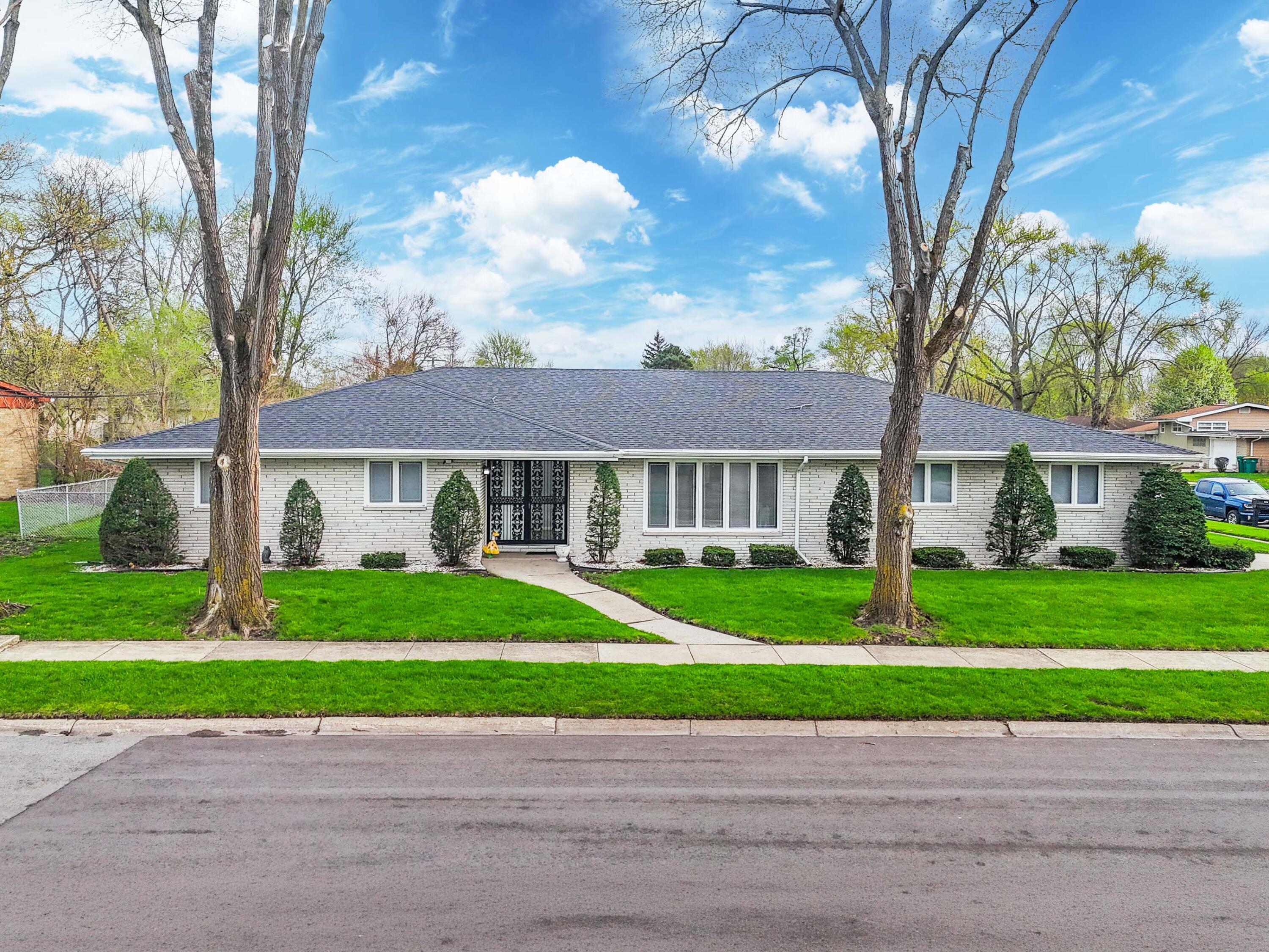 a house that has a tree in front of it