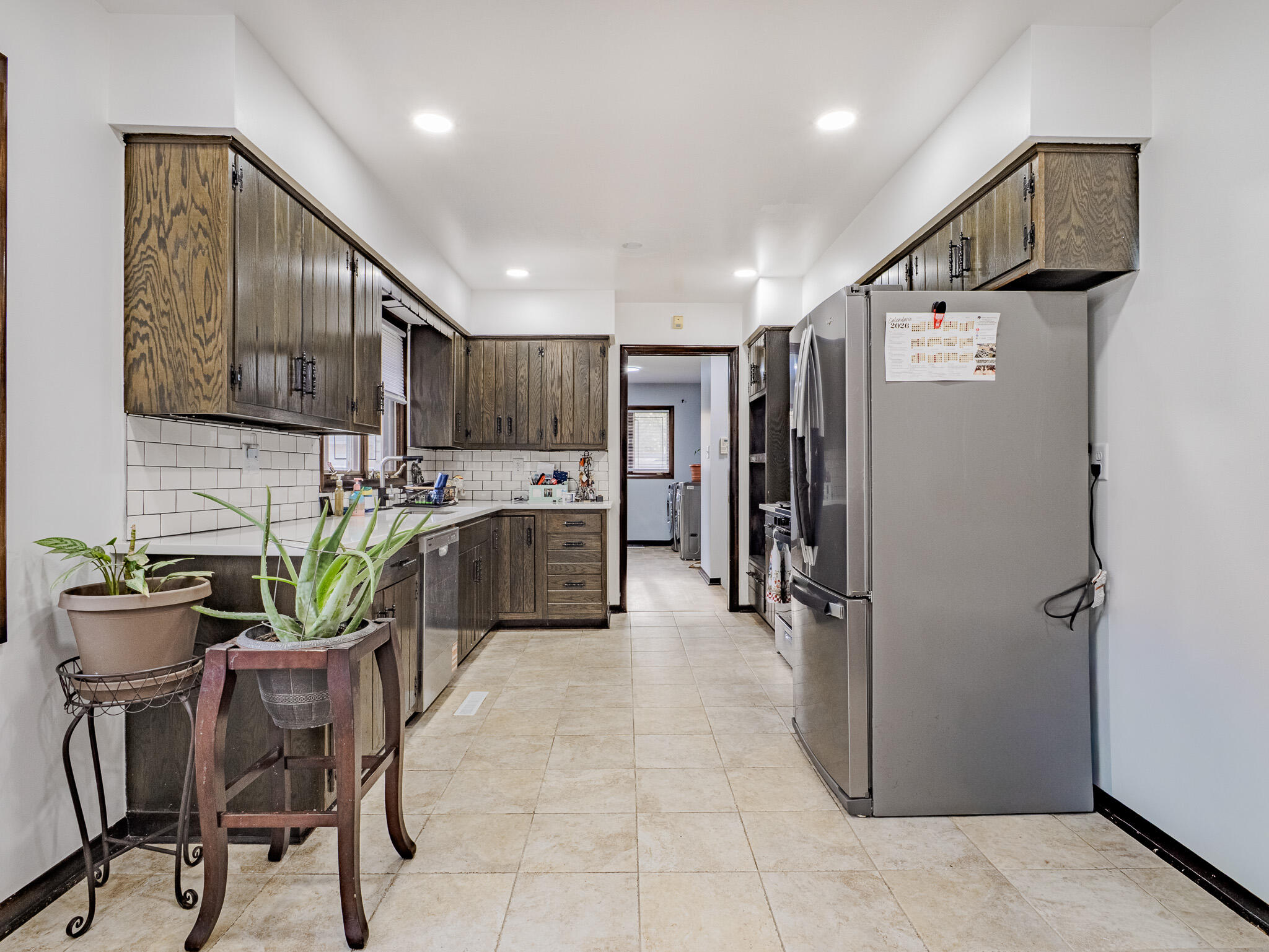 5301 Delaware Street Merrillville, IN 46410 - Photo 15 of 34 a kitchen with refrigerator cabinets and chairs