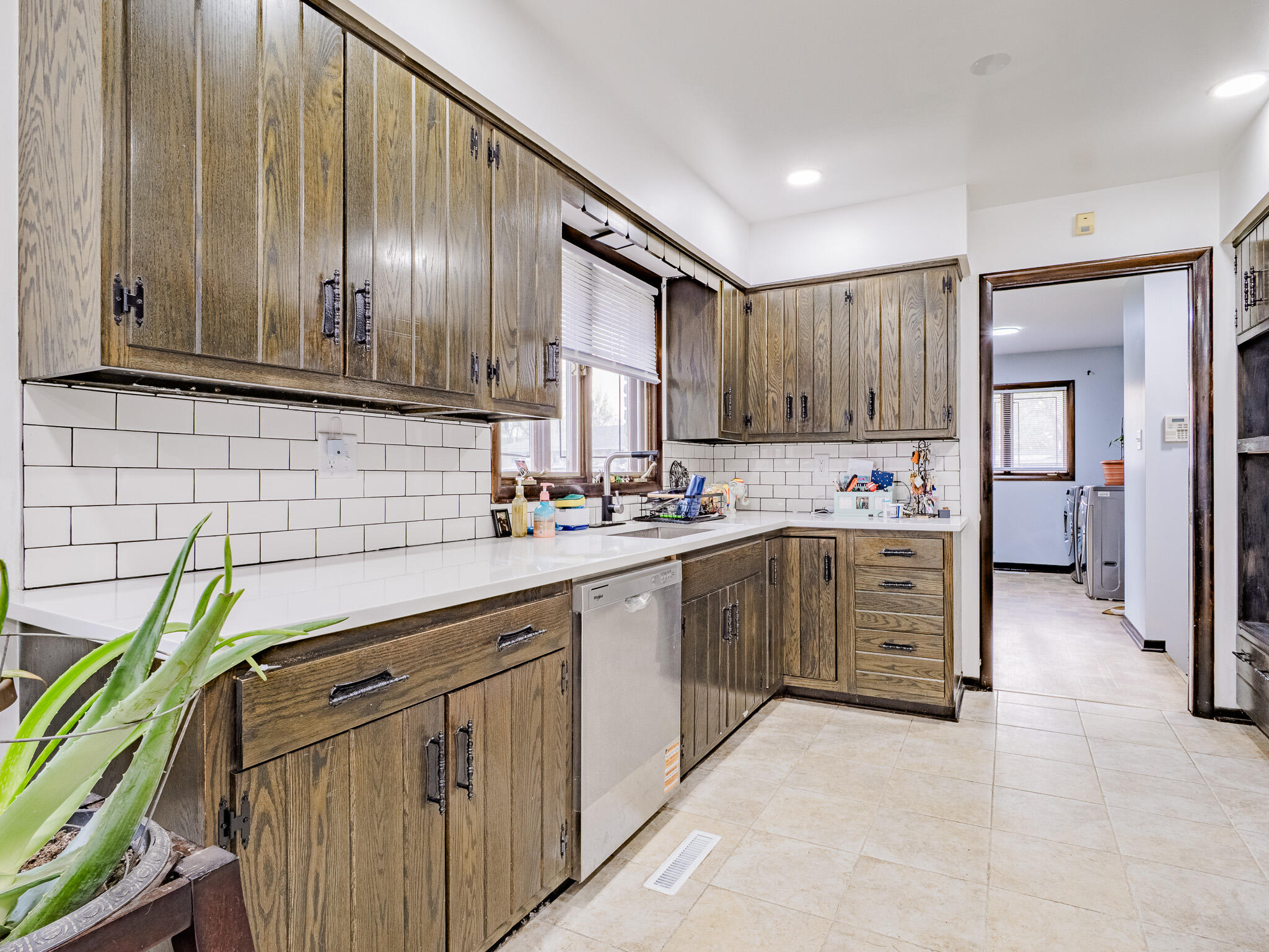 5301 Delaware Street Merrillville, IN 46410 - Photo 16 of 34 a kitchen with cabinets wooden floor and stainless steel appliances