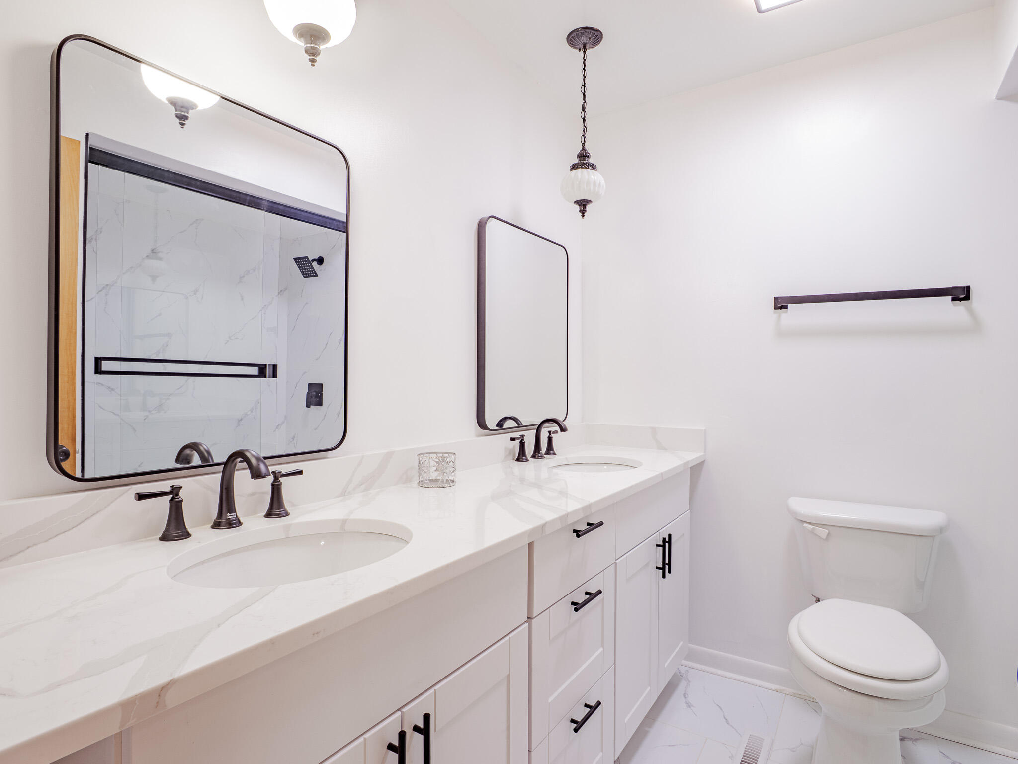 5301 Delaware Street Merrillville, IN 46410 - Photo 27 of 34 a bathroom with a double vanity sink toilet and mirror