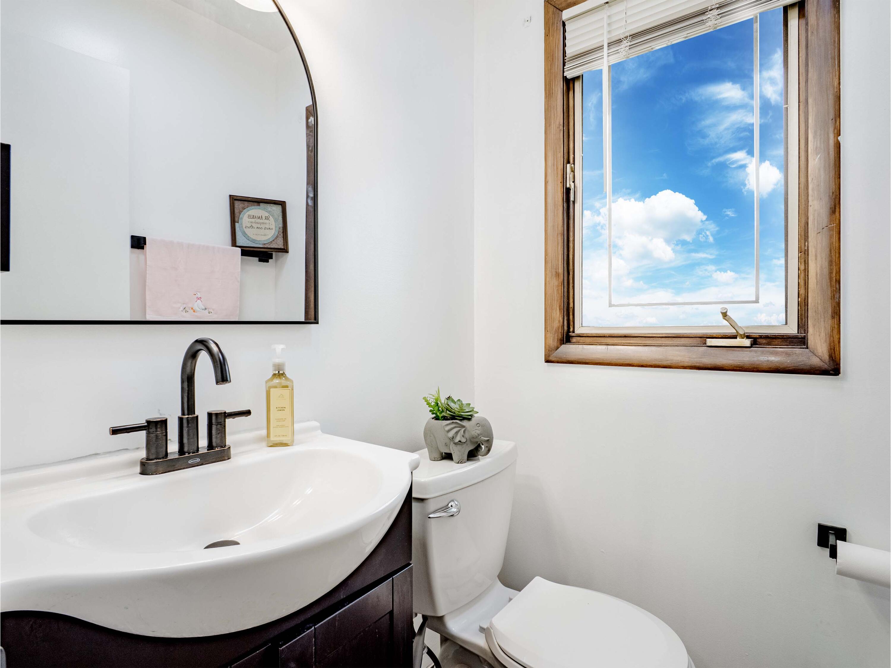 5301 Delaware Street Merrillville, IN 46410 - Photo 30 of 34 a bathroom with a sink and mirror with toilet