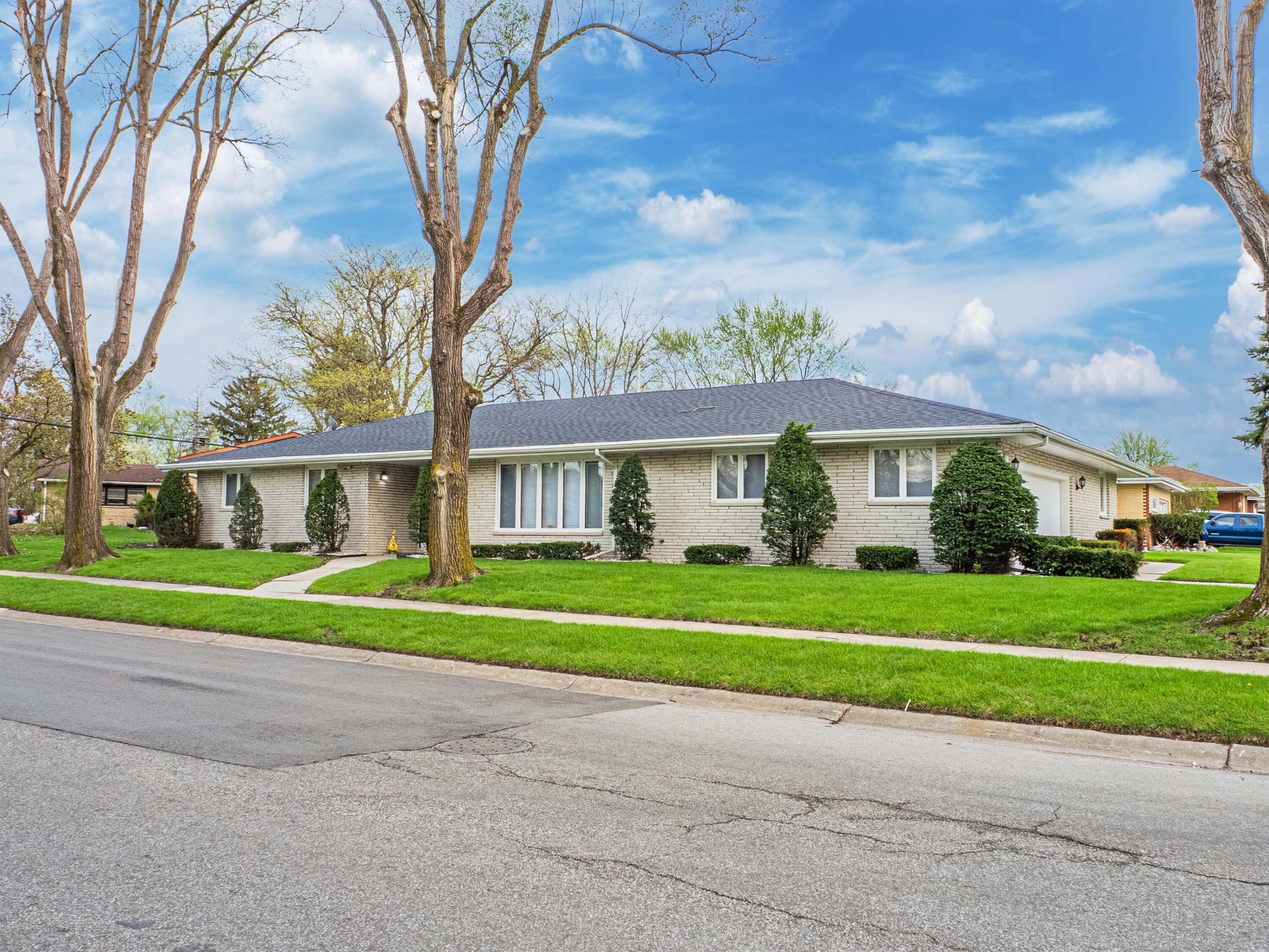 5301 Delaware Street Merrillville, IN 46410 - Photo 3 of 34 a front view of a house with a yard and trees