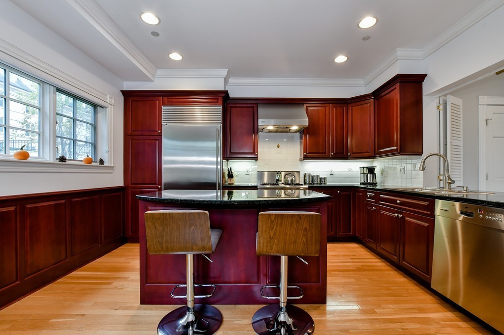 90 Constitution Road, Unit 90 Boston, MA 02129 - Photo 15 of 29 a kitchen with granite countertop a sink cabinets and window