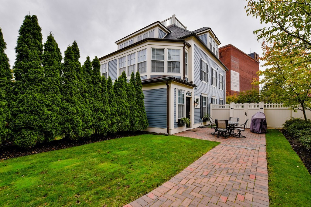 90 Constitution Road, Unit 90 Boston, MA 02129 - Photo 19 of 29 a front view of a house with a yard and trees