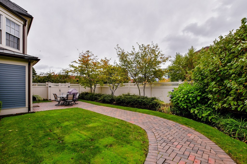 90 Constitution Road, Unit 90 Boston, MA 02129 - Photo 20 of 29 a view of a patio with a table and chairs under an umbrella