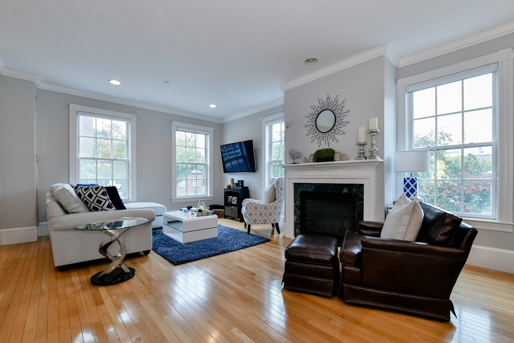 90 Constitution Road, Unit 90 Boston, MA 02129 - Photo 5 of 29 a living room with furniture and a fireplace
