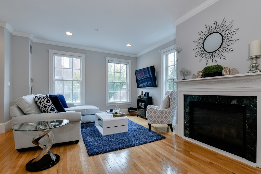 90 Constitution Road, Unit 90 Boston, MA 02129 - Photo 6 of 29 a living room with furniture a fireplace and a window