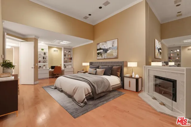 a spacious bedroom with a bed and a fireplace