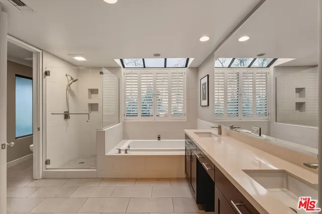 a spacious bathroom with a tub a sink and a shower