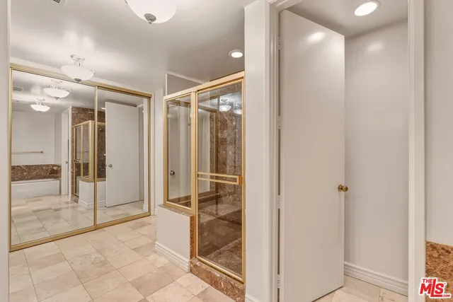a bathroom with a shower and a glass door