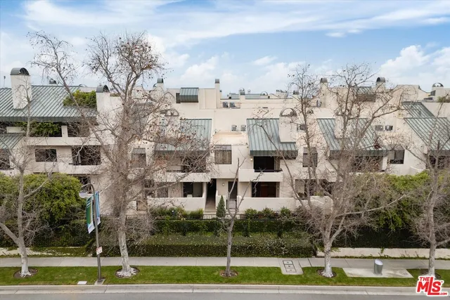 a aerial view of a white building with a yard