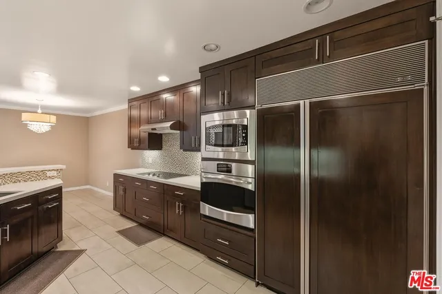 a kitchen with stainless steel appliances a refrigerator and a stove