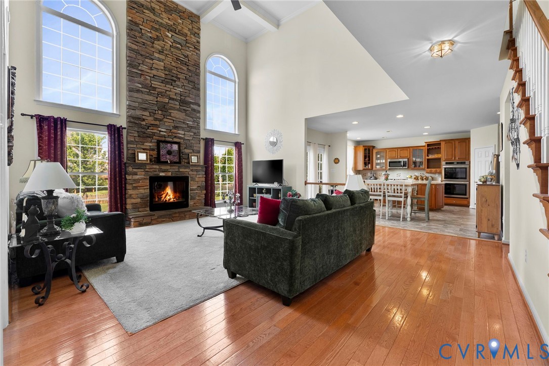 753 Blossom Tree Road Culpeper, VA 22701 - Photo 15 of 68 Two-story living area featuring a stone-clad firep