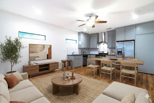 a living room with furniture kitchen view and a table