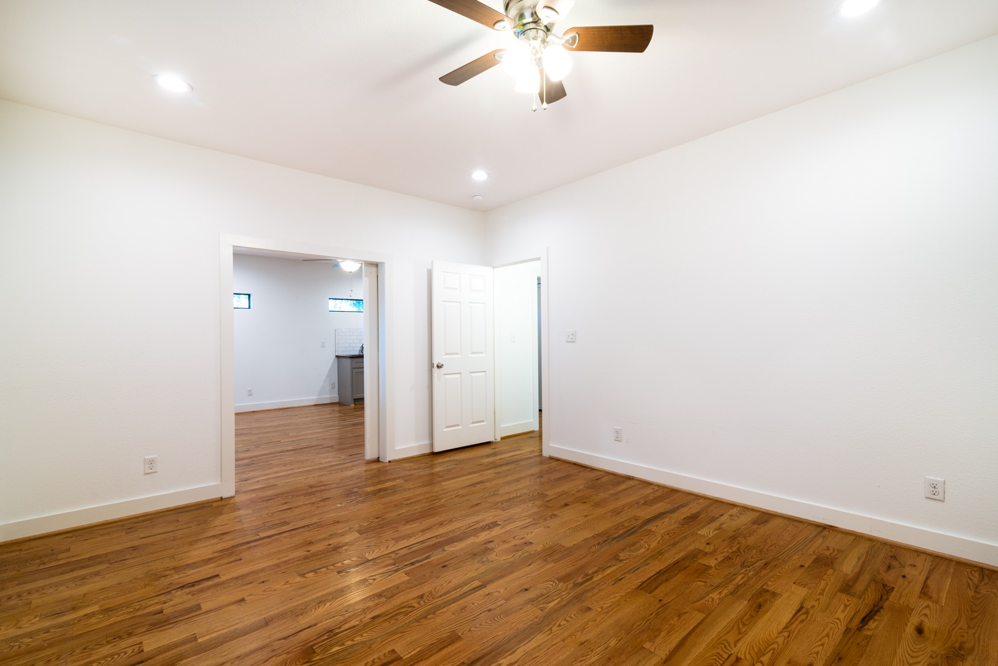 4734 Bell Street Houston, TX 77023 - Photo 12 of 42 an empty room with wooden floor and windows