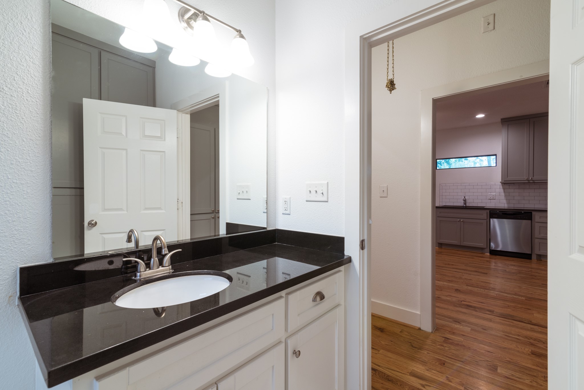 4734 Bell Street Houston, TX 77023 - Photo 14 of 42 a bathroom with a sink and a mirror