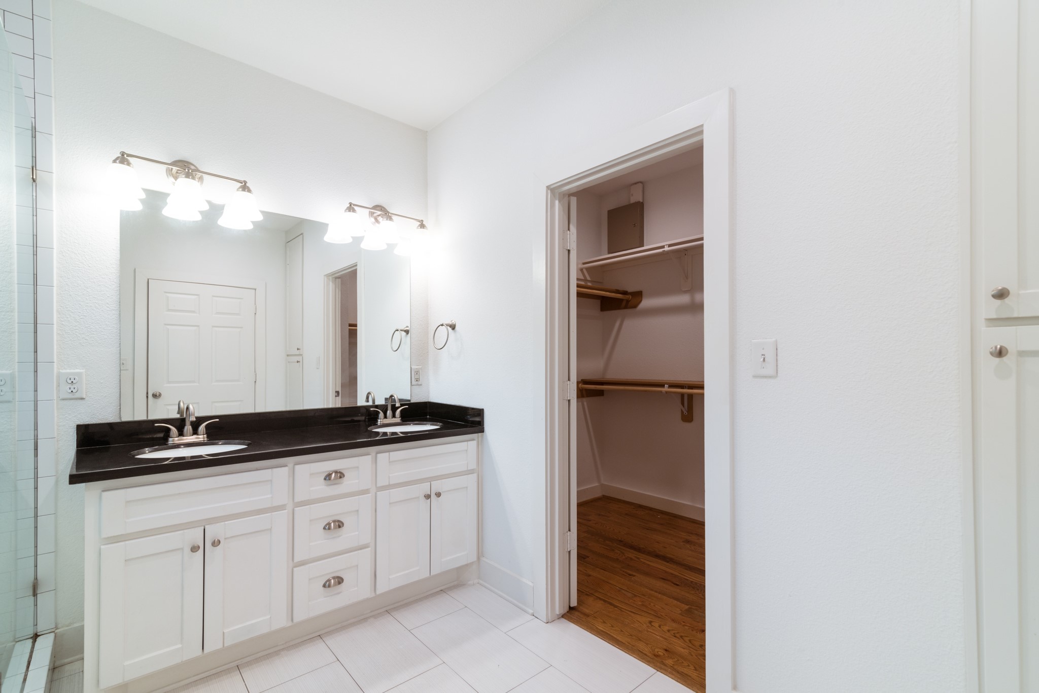 4734 Bell Street Houston, TX 77023 - Photo 20 of 42 a bathroom with a granite countertop sink and a mirror