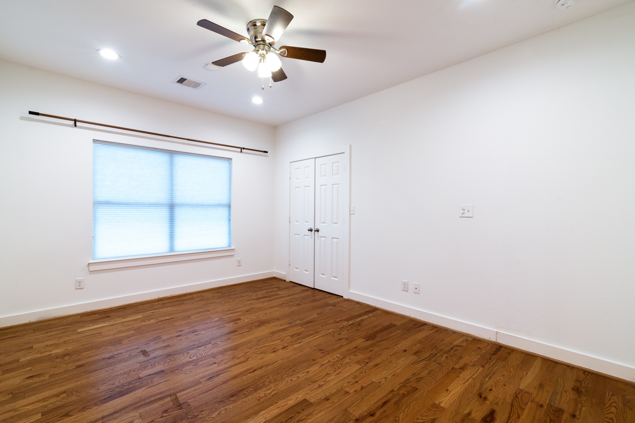 4734 Bell Street Houston, TX 77023 - Photo 22 of 42 wooden floor in an empty room with a window