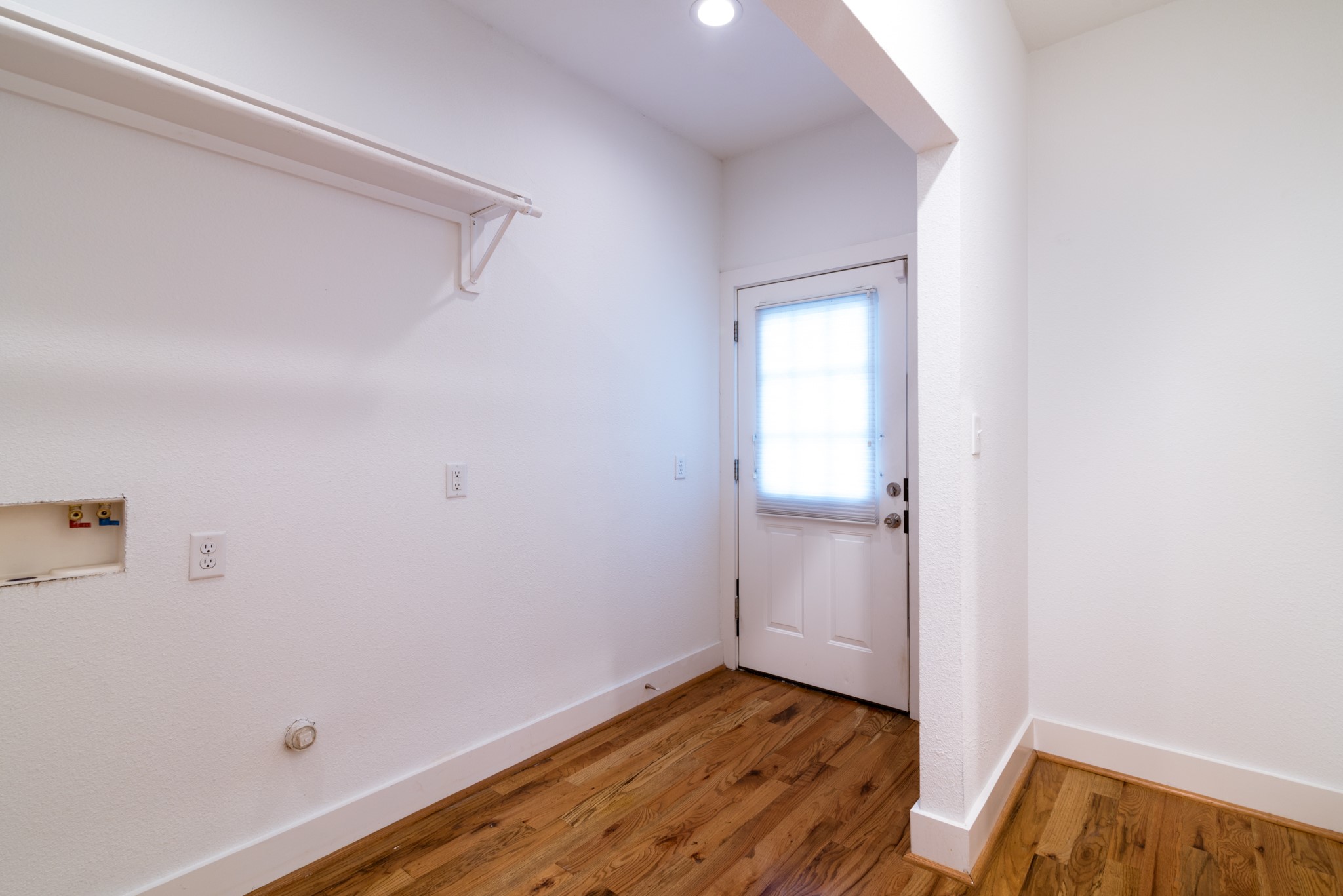 4734 Bell Street Houston, TX 77023 - Photo 24 of 42 a view of an empty room with wooden floor and a window