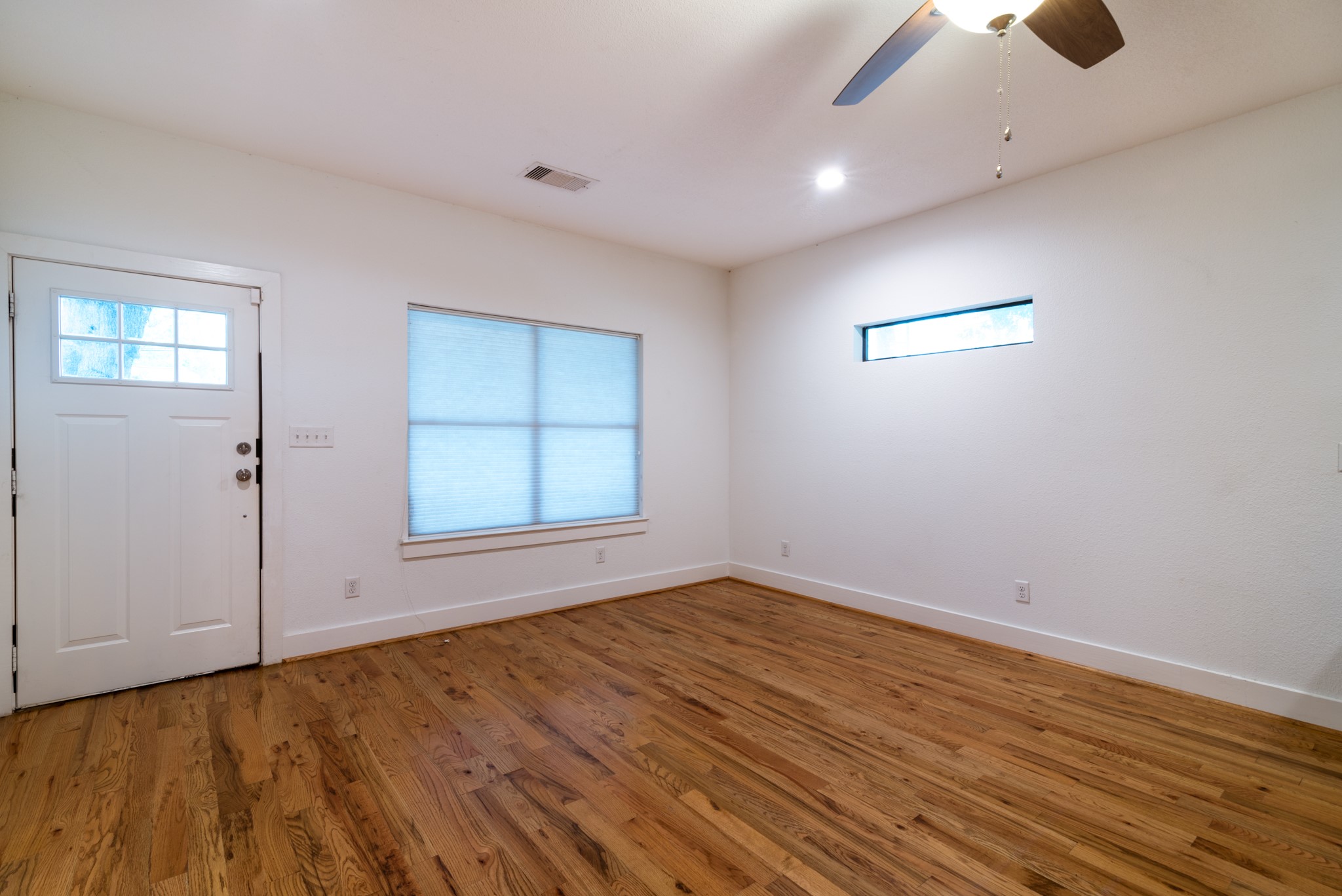 4734 Bell Street Houston, TX 77023 - Photo 6 of 42 wooden floor in an empty room with a window