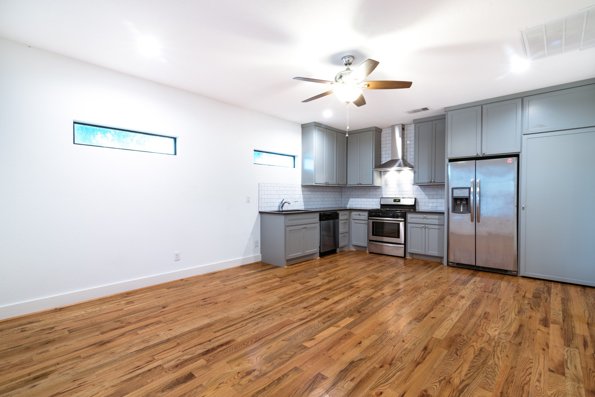 4734 Bell Street Houston, TX 77023 - Photo 7 of 42 a kitchen with stainless steel appliances a sink and a refrigerator