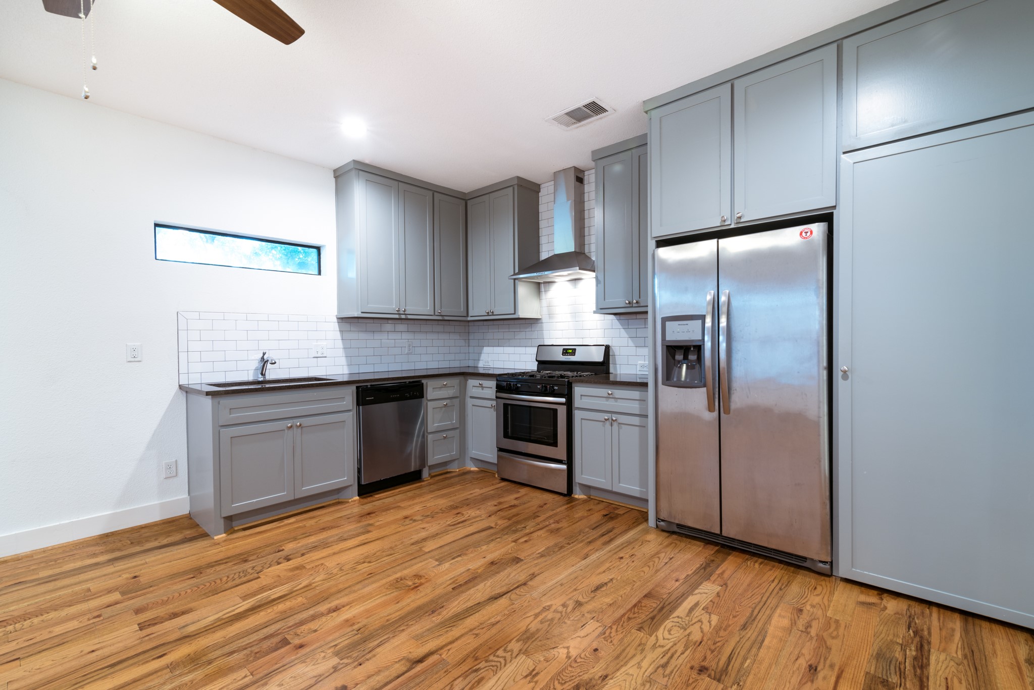 4734 Bell Street Houston, TX 77023 - Photo 9 of 42 a kitchen with a refrigerator and a sink