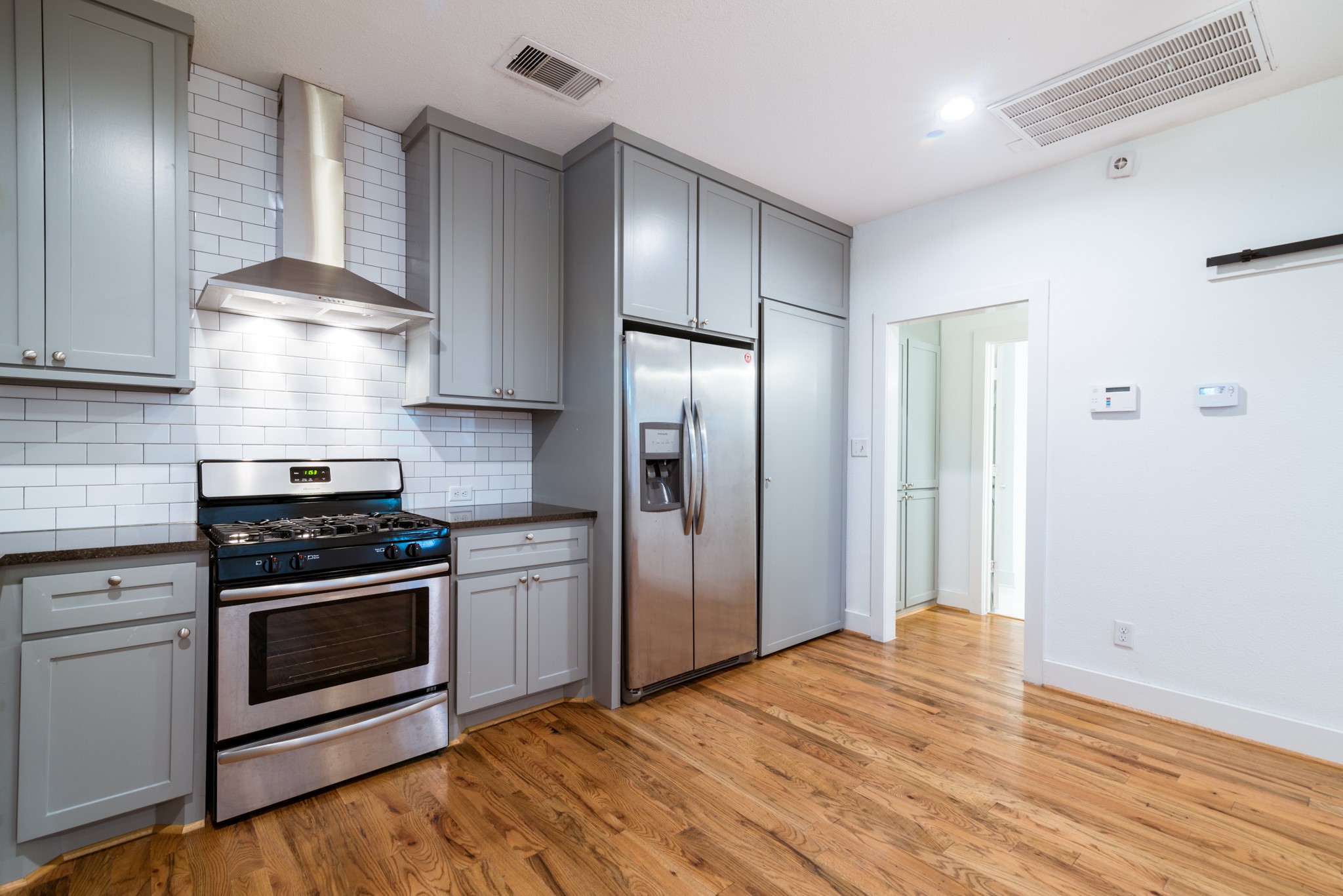 4734 Bell Street Houston, TX 77023 - Photo 10 of 42 a kitchen with a stove and a refrigerator