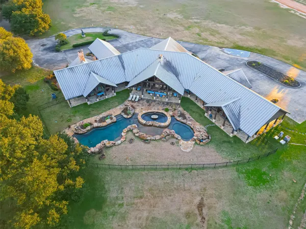 an aerial view of a house with outdoor space