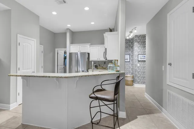 a kitchen with stainless steel appliances granite countertop a stove sink and cabinets