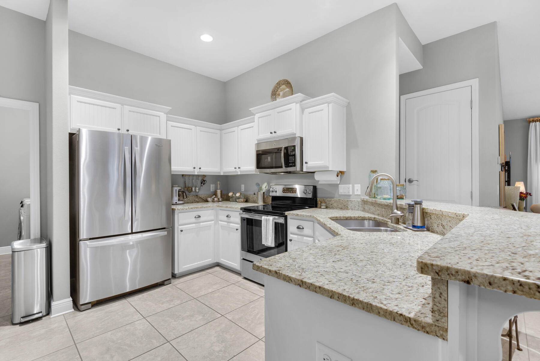 43 Hollyn Court Freeport, FL 32439 - Photo 13 of 35 a kitchen with granite countertop a refrigerator oven a sink dishwasher and a stove with wooden floor