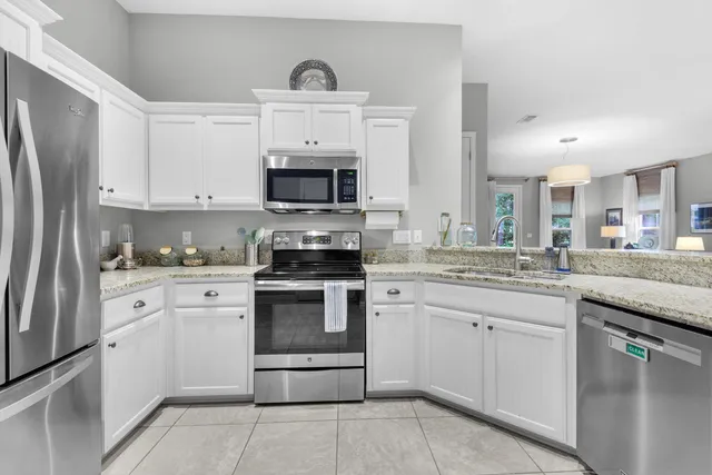 a spacious bedroom with a bed and a dresser