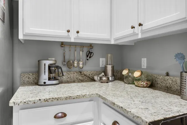 a bedroom with a bed and painting on the wall