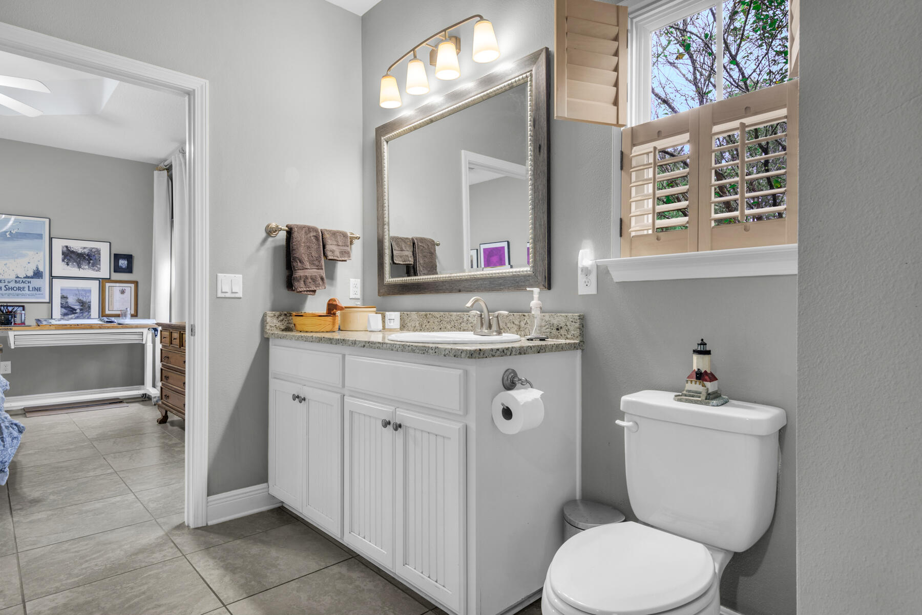43 Hollyn Court Freeport, FL 32439 - Photo 25 of 35 a bathroom with a granite countertop toilet sink and mirror