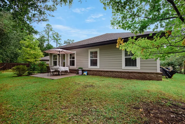 a view of a backyard with sitting area