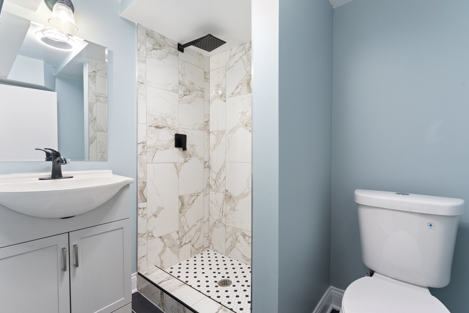 10954 South Normal Avenue Chicago, IL 60628 - Photo 11 of 17 a bathroom with a sink toilet and shower