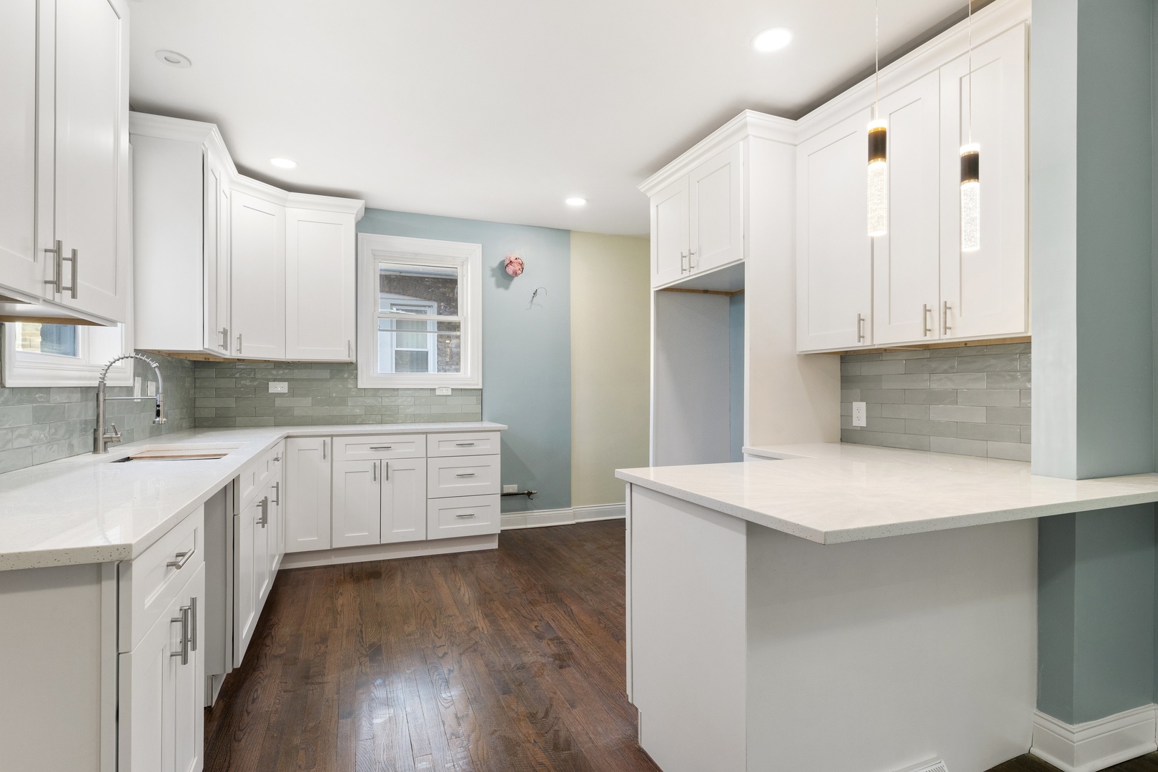 10954 South Normal Avenue Chicago, IL 60628 - Photo 6 of 17 a kitchen with stainless steel appliances white cabinets and wooden floors