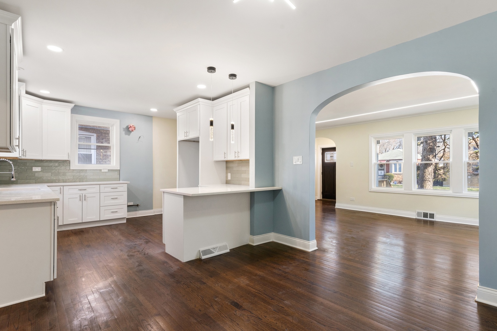 10954 South Normal Avenue Chicago, IL 60628 - Photo 8 of 17 a living room with wooden floors and white walls
