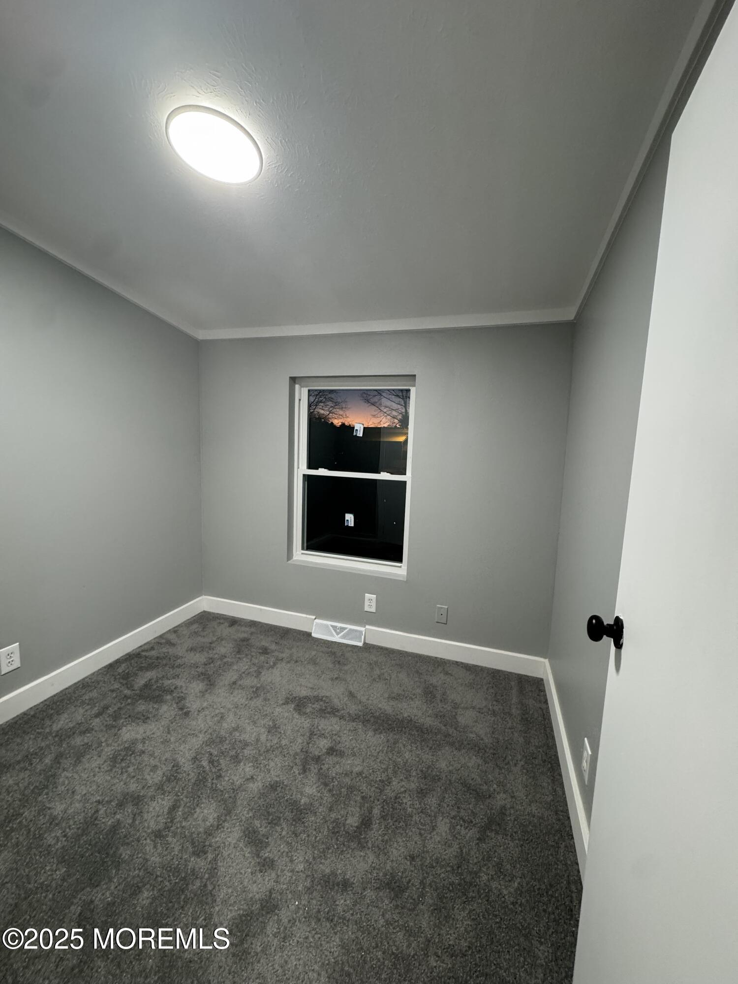 406 4th Street Jackson, NJ 08527 - Photo 11 of 13 an empty room with a natural light