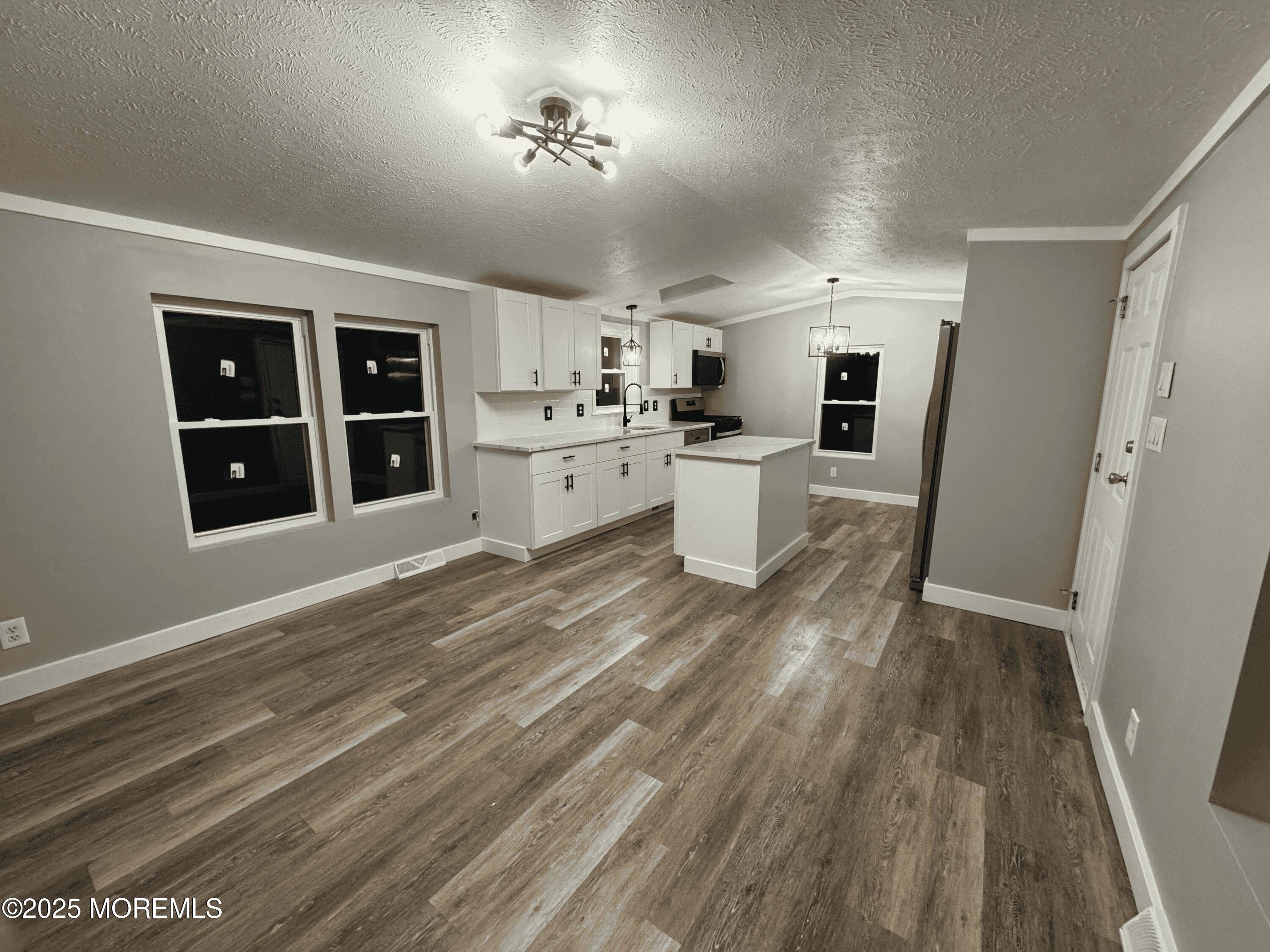 406 4th Street Jackson, NJ 08527 - Photo 2 of 13 a view of a kitchen with cabinets and wooden floor