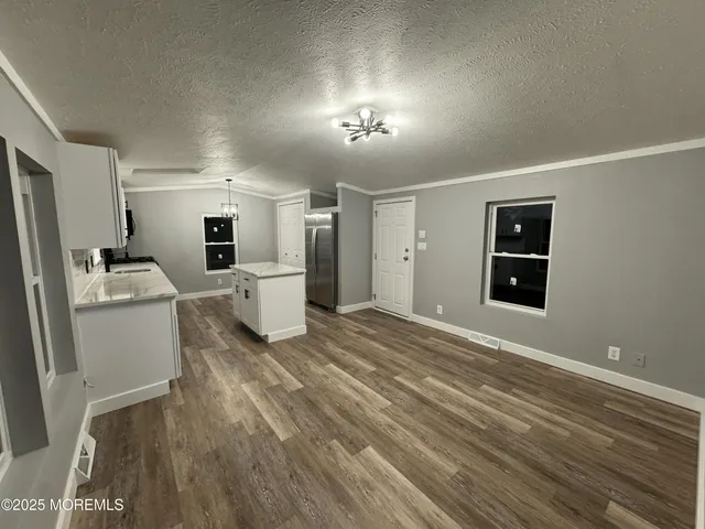 a view of a kitchen with a sink refrigerator and window