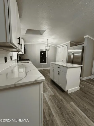 a kitchen with stainless steel appliances granite countertop a sink a stove and a microwave oven