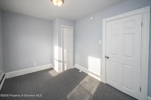 a view of an empty room and closet area