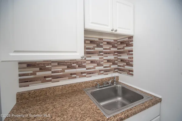 a kitchen with a sink a stove and cabinets