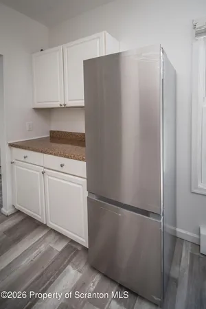 a kitchen with a refrigerator and cabinets